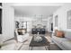 Open-concept living space with modern furnishings, seamlessly connecting to a stylish kitchen at 17366 Newton Main St, Westfield, IN 46074