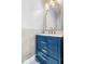 Stylish bathroom features a blue vanity with marble countertops and gold fixtures at 2227 Hidden Orchard Ct, Indianapolis, IN 46228