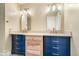 Bathroom featuring double vanity with two different cabinet styles and sleek mirrors at 2227 Hidden Orchard Ct, Indianapolis, IN 46228