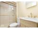 Bathroom featuring a glass shower, white tiled walls, and a matching sink with gold fixtures at 2227 Hidden Orchard Ct, Indianapolis, IN 46228