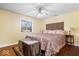Comfortable bedroom with a large window providing natural light and a stylish ceiling fan at 2227 Hidden Orchard Ct, Indianapolis, IN 46228