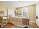 Bright bedroom with a patterned quilt and a decorative white headboard at 2227 Hidden Orchard Ct, Indianapolis, IN 46228