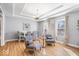 Dining area featuring a tray ceiling, modern furniture, and natural light at 2227 Hidden Orchard Ct, Indianapolis, IN 46228