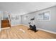 Spacious home gym with exercise equipment, laminate flooring, and staircase in view at 2227 Hidden Orchard Ct, Indianapolis, IN 46228