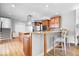 Spacious kitchen boasts stainless appliances, granite countertops, and breakfast bar with seating at 2227 Hidden Orchard Ct, Indianapolis, IN 46228