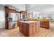 Gourmet kitchen with stainless steel appliances, granite counters, and large center island with seating at 2227 Hidden Orchard Ct, Indianapolis, IN 46228