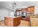 This kitchen features custom wood cabinets, stainless appliances, and a large kitchen island at 2227 Hidden Orchard Ct, Indianapolis, IN 46228