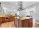Open kitchen with granite counters, an island cooktop, and modern stainless steel appliances at 2227 Hidden Orchard Ct, Indianapolis, IN 46228