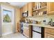Functional kitchenette with wooden cabinets, compact refrigerator, and countertop appliances at 2227 Hidden Orchard Ct, Indianapolis, IN 46228
