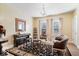 Elegant living room has a piano, chandelier, and large windows, with a gorgeous oriental rug at 2227 Hidden Orchard Ct, Indianapolis, IN 46228