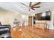 Spacious living room featuring beautiful hardwood floors and a ceiling fan to keep it cool at 2227 Hidden Orchard Ct, Indianapolis, IN 46228