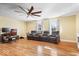 Inviting living room with hardwood floors, featuring comfortable seating and natural light from two windows at 2227 Hidden Orchard Ct, Indianapolis, IN 46228