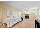 Large room featuring wood floors, fireplace, a room divider, and a bed, suitable for multi-purpose use at 2227 Hidden Orchard Ct, Indianapolis, IN 46228