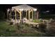 Outdoor pergola with string lights, stone flooring, plantings, and outdoor seating is perfect for relaxation and entertaining at 2227 Hidden Orchard Ct, Indianapolis, IN 46228