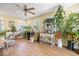 Bright sunroom with a ceiling fan and lots of natural light from numerous windows at 2227 Hidden Orchard Ct, Indianapolis, IN 46228