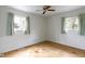 Simple bedroom with hardwood floors, two windows, and a ceiling fan at 1024 N Michigan St, Greenfield, IN 46140