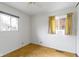 This room has parquet floors, two windows, a ceiling fan, and neutral colored walls at 1024 N Michigan St, Greenfield, IN 46140