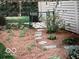 Nice landscaping featuring a stepping stone path, greenery, flower beds, and a fence at 1024 N Michigan St, Greenfield, IN 46140