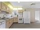 This kitchen features wooden cabinets and white appliances at 1024 N Michigan St, Greenfield, IN 46140