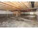Unfinished basement with exposed beams and concrete floor at 15468 Streamwood Dr, Fishers, IN 46037
