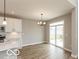 Bright dining area featuring modern chandelier and sliding doors to the backyard at 15468 Streamwood Dr, Fishers, IN 46037