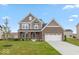 Charming two-story home with a well-manicured lawn, brick accents and attached two car garage at 15468 Streamwood Dr, Fishers, IN 46037