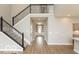 Open foyer with staircase, hardwood floors, and views of the home's entry and adjacent kitchen at 15468 Streamwood Dr, Fishers, IN 46037