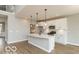 Modern kitchen featuring white cabinets, stainless steel appliances, a large island with pendant lighting at 15468 Streamwood Dr, Fishers, IN 46037