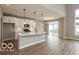 Modern kitchen featuring white cabinets, stainless steel appliances, a large island with pendant lighting at 15468 Streamwood Dr, Fishers, IN 46037