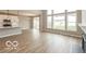 Bright living room showcasing an open plan with a fireplace and kitchen at 15468 Streamwood Dr, Fishers, IN 46037