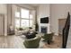 Spacious living room with tall ceilings, a large window, fireplace, and stylish decor, creating an inviting atmosphere at 15468 Streamwood Dr, Fishers, IN 46037