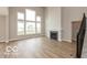 Bright living room showcasing a fireplace and large windows at 15468 Streamwood Dr, Fishers, IN 46037