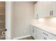 Spacious pantry with white cabinets, drawers, counter space, and wire shelving for optimal storage at 15468 Streamwood Dr, Fishers, IN 46037