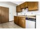 A classic kitchen showcasing wood cabinets, a dishwasher, and functional layout with tile floor at 8016 Minlo Dr, Indianapolis, IN 46227