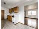 An open kitchen concept with wood cabinets and tile floors leading into the living area at 8016 Minlo Dr, Indianapolis, IN 46227