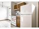 Bright kitchen featuring white appliances, tile floors, and wood cabinets, functional and stylish at 8016 Minlo Dr, Indianapolis, IN 46227