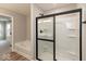 Bathroom with a glass shower, tub, and neutral paint and flooring at 1019 Cyprian Way, Lebanon, IN 46052