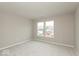 Carpeted bedroom showcasing a large window and neutral paint at 1019 Cyprian Way, Lebanon, IN 46052