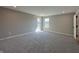 Spacious bedroom featuring plush gray carpet, neutral walls, and natural light from two windows at 1019 Cyprian Way, Lebanon, IN 46052