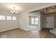 Elegant dining area featuring modern chandelier and an entry to carpeted living room at 1019 Cyprian Way, Lebanon, IN 46052
