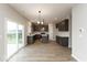Open concept kitchen with gray cabinets, stainless appliances, and an island flowing into dining area at 1019 Cyprian Way, Lebanon, IN 46052