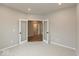Office space featuring carpet, neutral walls, and double doors at 1019 Cyprian Way, Lebanon, IN 46052