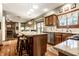 Kitchen with granite counters, wood cabinets, and stainless steel appliances at 11116 Knightsbridge Ln, Fishers, IN 46037