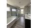 A primary bathroom with a double sink vanity, standing shower and separate soaking tub at 12023 Crestwater Ct, Fishers, IN 46037