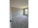Bedroom with gray walls and plush carpet and a large window at 12023 Crestwater Ct, Fishers, IN 46037