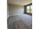 Bedroom with gray walls, carpet flooring, and a large window providing natural light at 12023 Crestwater Ct, Fishers, IN 46037