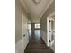 Long view down a hallway with hard surface floors into a spacious living area at 12023 Crestwater Ct, Fishers, IN 46037