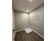An organized laundry room featuring wooden floors, a metal shelf, and washer and dryer hookups at 12023 Crestwater Ct, Fishers, IN 46037
