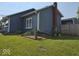 View of the home's exterior showing the fenced yard and landscaping at 1517 N E St, Elwood, IN 46036