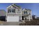 Two-story house with gray siding, white garage door, and brick accents at 3943 Seeger St, Indianapolis, IN 46239